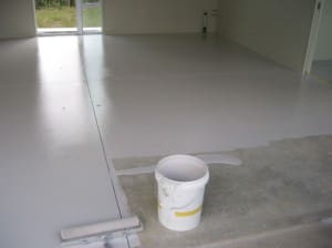 Applying a specialist epoxy paint to a garage floor.