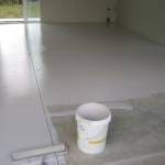Applying a specialist epoxy paint to a garage floor.